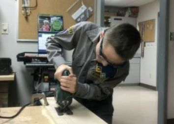 boy cutting wood